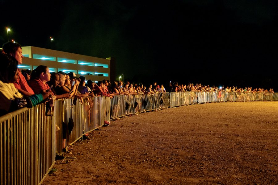 Students line up against the barrier and watch as the torch-shaped bonfire burns after the concert. Mohammed F Emran | Contributing photographer