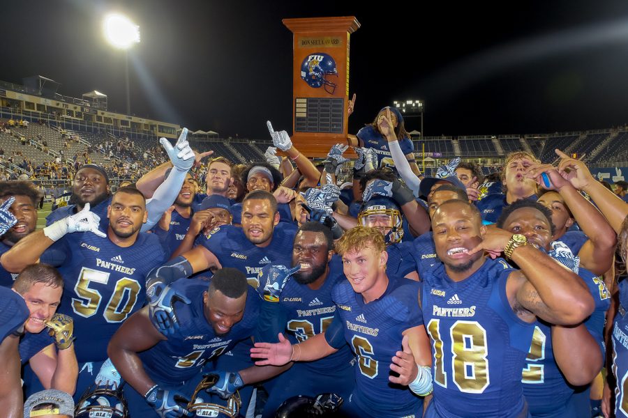 FIU players celebrate with the Shula Bowl trophy after winning against FAU 33-31. This was FIU’s fourth Shula Bowl win ever. Mohammed F Emran | Staff Photographer