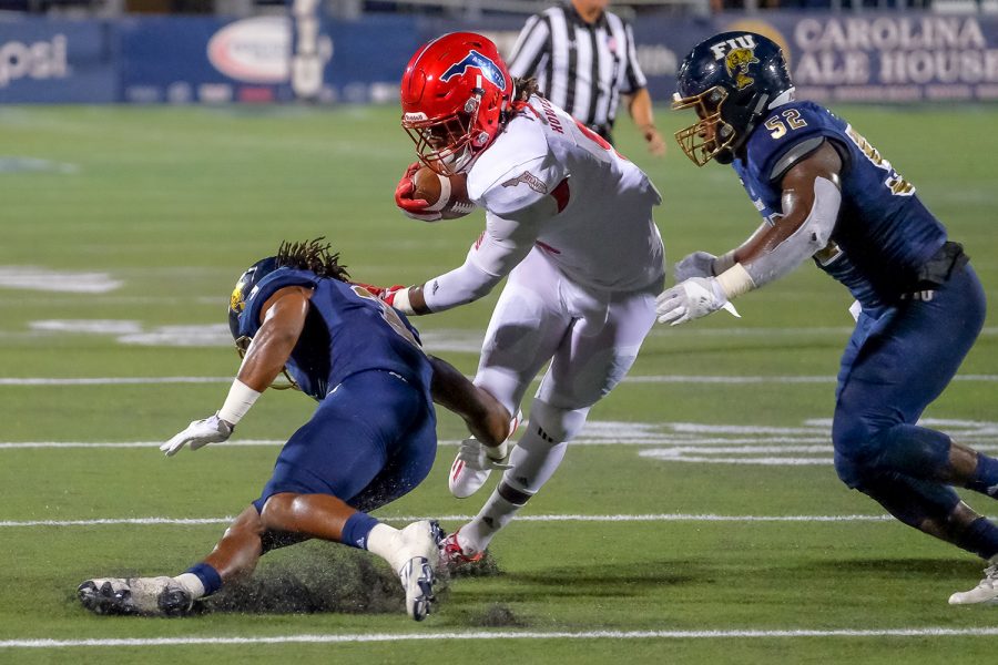 Owls running back Gregory Howell (9) runs pass an FIU defender before being tackled by Panthers linebacker Treyvon Williams (52). Mohammed F Emran | Staff Photographer