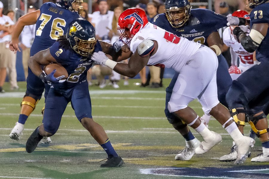 Panthers running back Anthony Jones (2) is tackled by Owls offensive line Reggie Bain (58). FIU did not earn any yards on the play. Mohammed F Emran | Staff Photographer