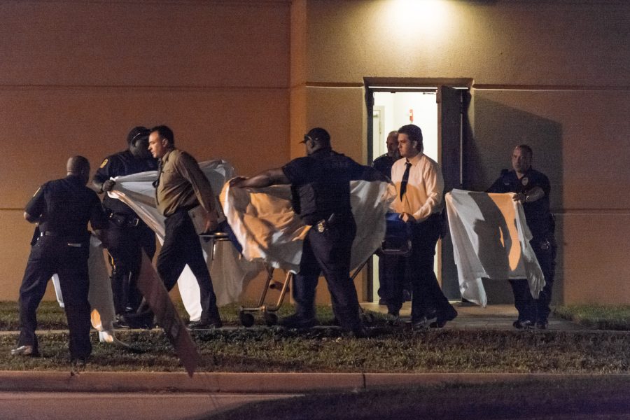 FAU Police officers and other personnel escort a stretcher to a waiting van. Jonathan Scott | Contributing Photographer
