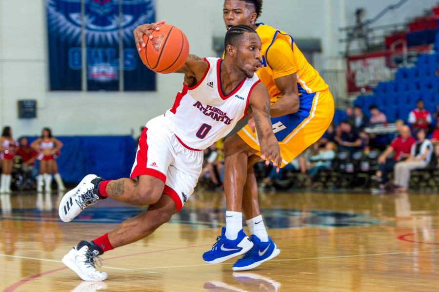  Adonis Filer (0) dribbles around a Hofstra guard on his way to the basket. 