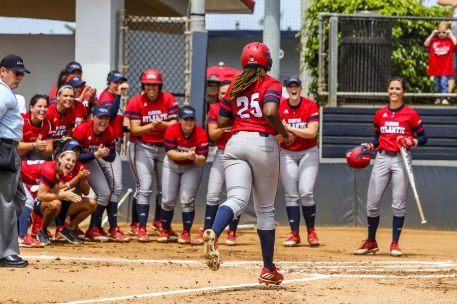 The Owls wait for junior Emily Lochten to cross home plate after her 15th home run of the season. Alexander Rodriguez | Contributing Photographer