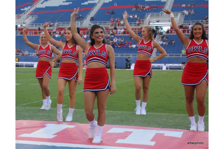 (From left to right) Sophomore Gabbe Moore, freshman Sydney Hafen, freshman Karina Cruz and sophomore Sierra Teska wave to the crowd during a football game. 
Photo courtesy of FAU Athletics