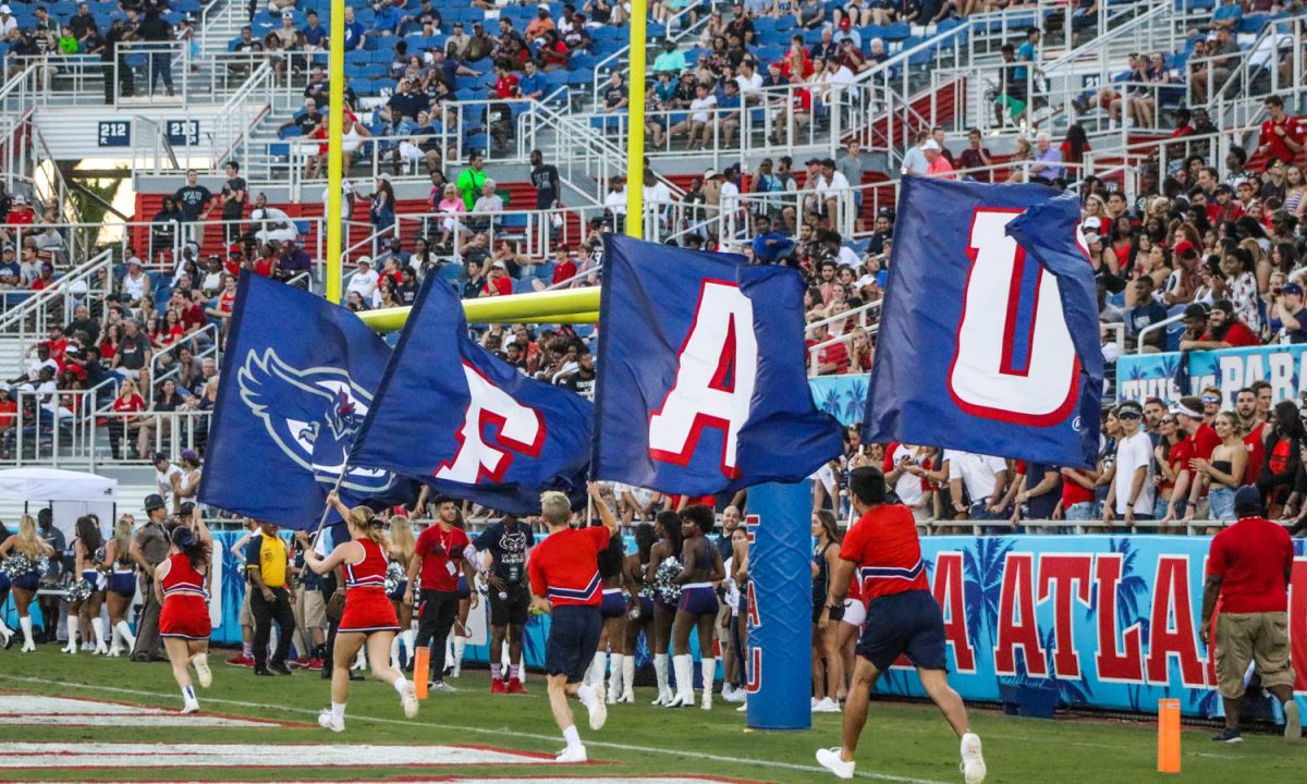 FAU cheerleaders wave their flags after the Owls scored a touchdown during their game against Bethune-Cookman on Sept. 16. Lauren Sopourn | Contributing Photographer
