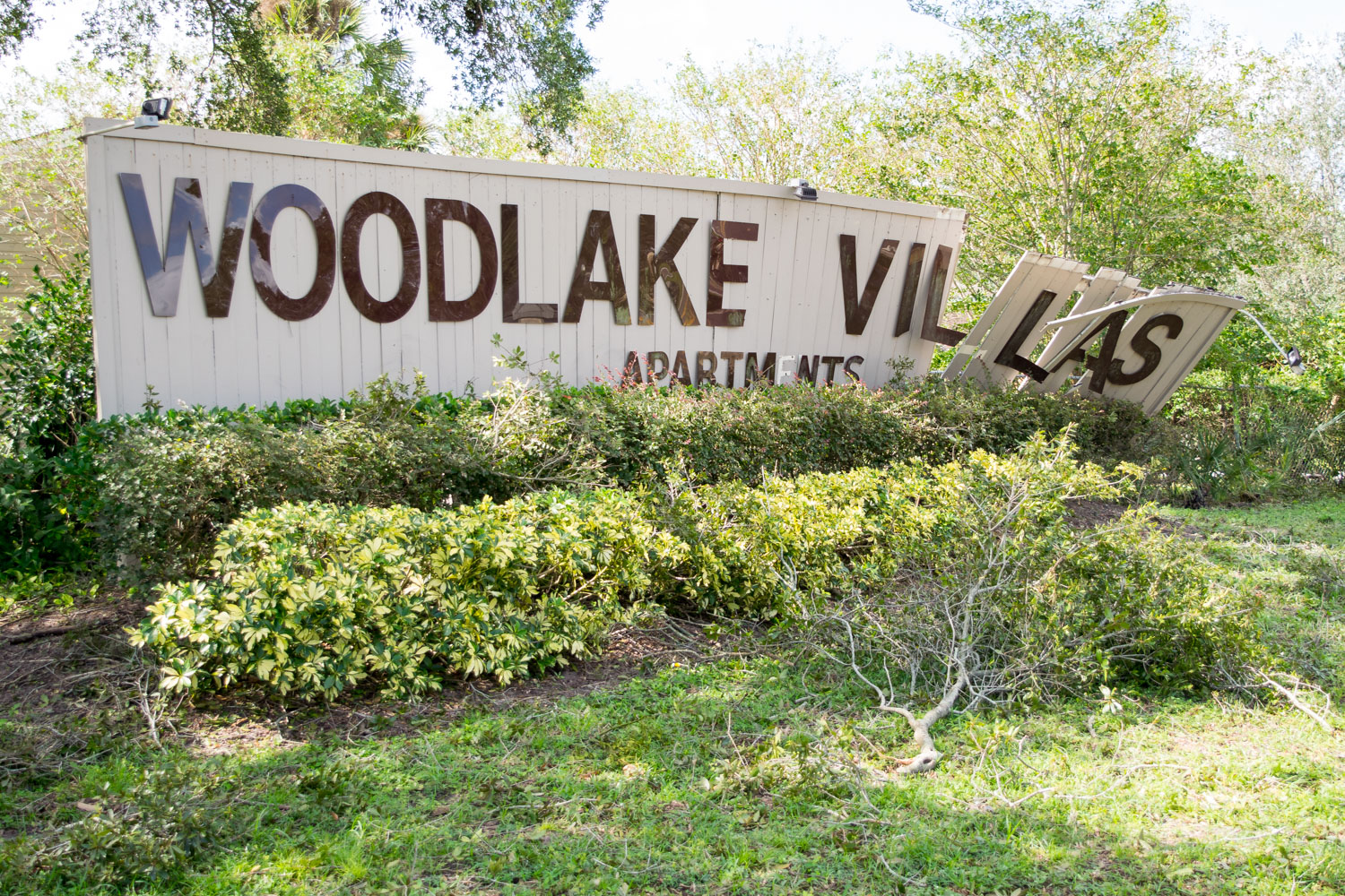 A sign for the Woodlake Villas leans damaged by the Hurricane. Some areas in the city received downed trees and power lines, while others faced little or no problems. Ryan Lynch | Business Manager