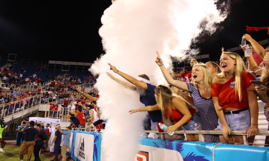 FAU+fans+cheer+and+scream+through+the+smoke+as+FAU+sophomore+running+back+Devin+Singletary+%285%29+scores+a+touchdown.+Matthew+Quick+%7C+Contributing+Photographer