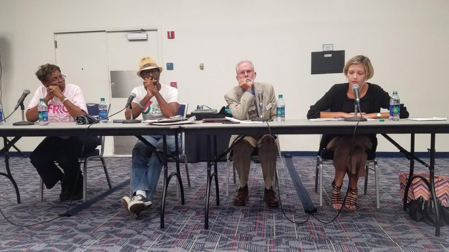 Panelists (from left to right) Geraldine Harriel, Roderick Kemp, Mark Schneider and Dr. Wendy Hinshaw talking about their motivations to become activists for voting rights of former felons. Photo by Amber Kelley.