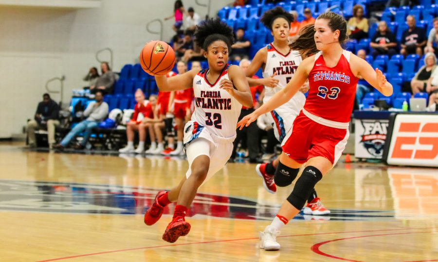 FAU senior guard Malia Kency (32) dribbles around Saint Francis sophomore guard Jade Johnson (23). FAU went on to win 80-60 against Saint Francis during their Thanksgiving Tourney. Lauren Sopourn | Contributing Photographer