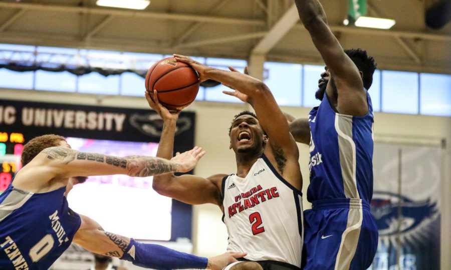 FAU senior guard Justin Massey (2) powered through Middle Tennessees defense to get a layup in. FAU went on to lose against MTSU 61-57 on Jan. 6. Joshua Giron | Photo Editor