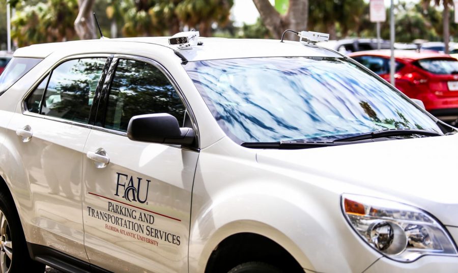 A parking and transportation employee brings the vehicle to the front of the Student Support Service building that is equipped with two sensor cameras on top of the vehicle that will scan each license plate when driving down FAU parking lots. | Alexander Rodriguez