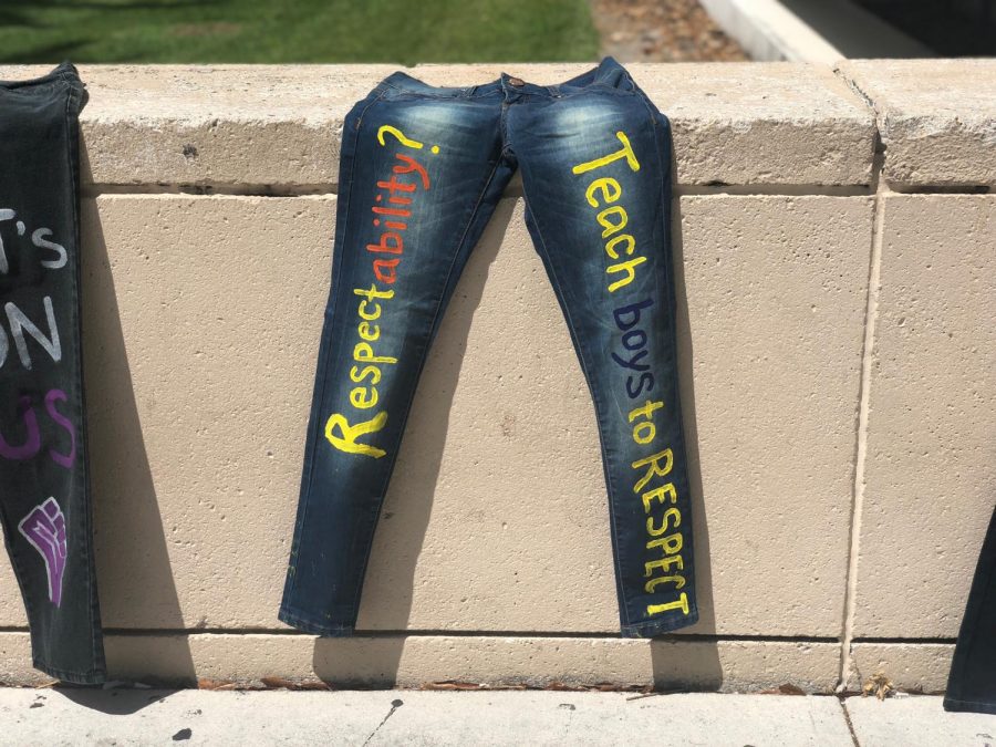 A pair of painted jeans reading Respectability? Teach boys to respect was set out to dry in the sun by the library. Joshua Giron | Photo Editor