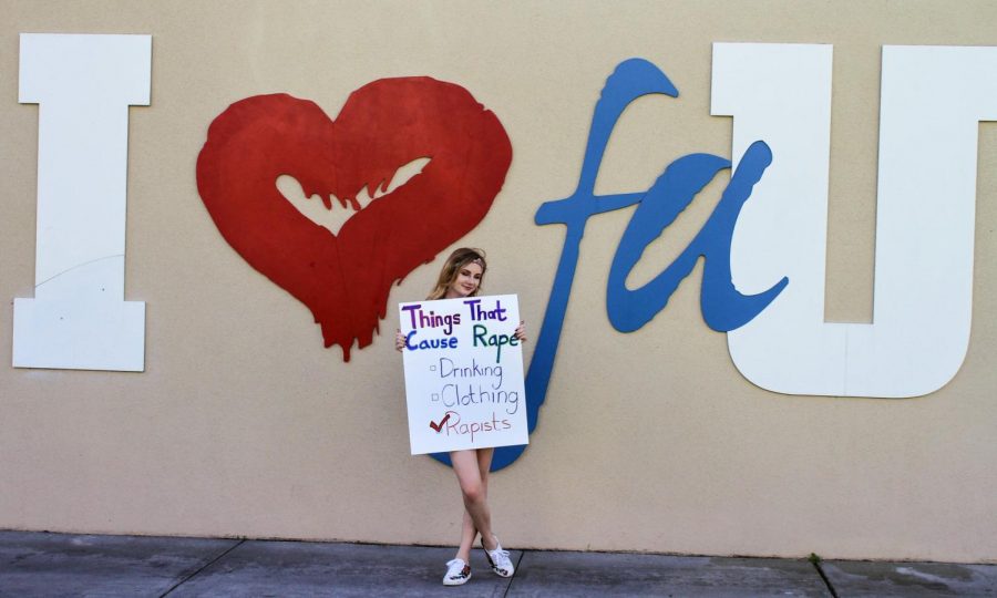 FAU freshman and business major April McPherson holds a sign during the spring 2018 Slut Walk, an event promoting consent and body positivity. The message on her sign is a core belief of Flip the Script — a scientifically proven sexual assault prevention course only available at FAU in the U.S. Photo by Violet Castano