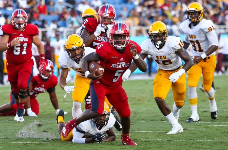 FAU junior running back Devin Singletary (5) outruns a defensive Bethune-Cookman player before scoring a touchdown for FAU. Photo by: Alexander Rodriguez
