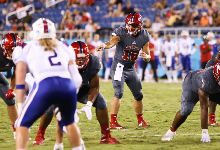 FAU graduate student quarterback Rafe Peavey (16), who was the starting quarterback against LA Tech signals to his teammates to prepare for play. Photo by: Alexander Rodriguez
