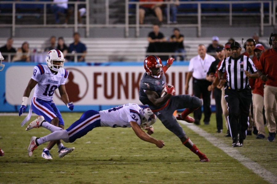 FAU redshirt junior running back Kerrith Whyte Jr. (6) attempts to run down the sideline against LA Tech and narrowly misses getting tackled. Photo by: Pierce Herrmann

