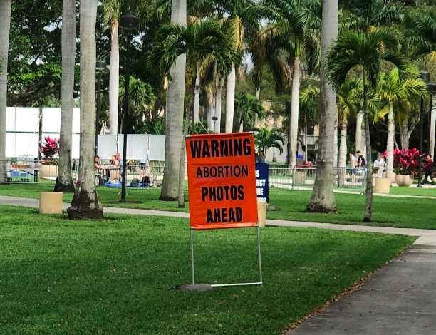 The anti-abortion protests often have warning signs in front of them. Photo courtesy of the FAU National Organization of Women Twitter.