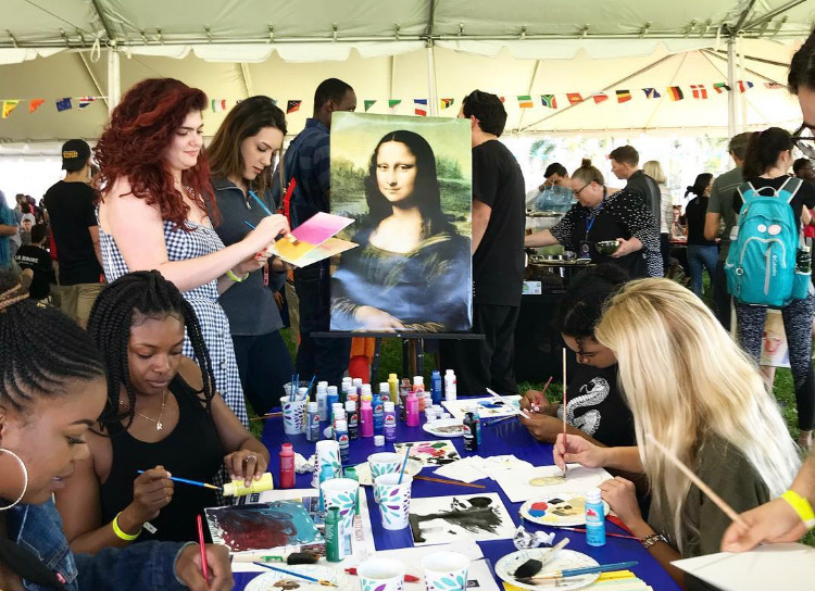 Inside the Festival of Nations tent that was lined with flags from different countries, students attempted to recreate the famous Mona Lisa painting by Italian artist Leonardo da Vinci. Photo courtesy of FAU Graduate Colleges Twitter