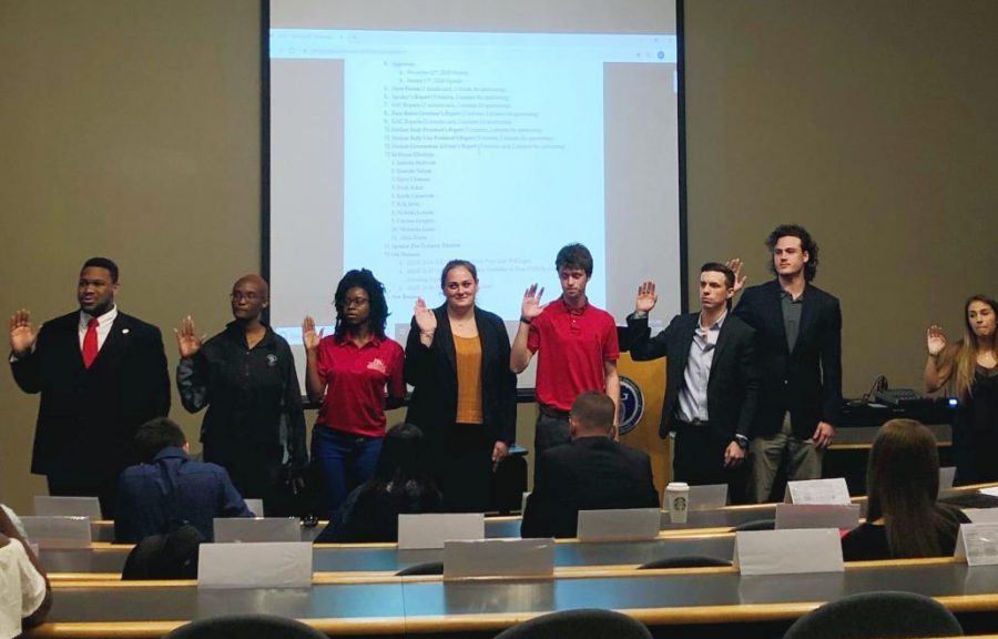 Seven representatives being sworn into the House by Speaker Joshua Rutledge (left).