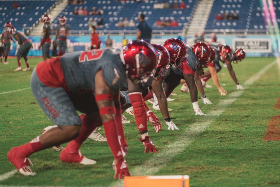 FAU’s defensive line warms up before last weeks game against Western Kentucky. Photo by Alex Liscio.