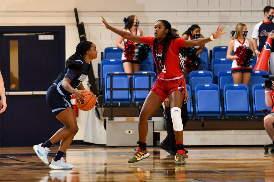 Amber Gaston (pictured red, #32) had 16 points in the loss to Old Dominion. Photo courtesy of FAU Athletics.