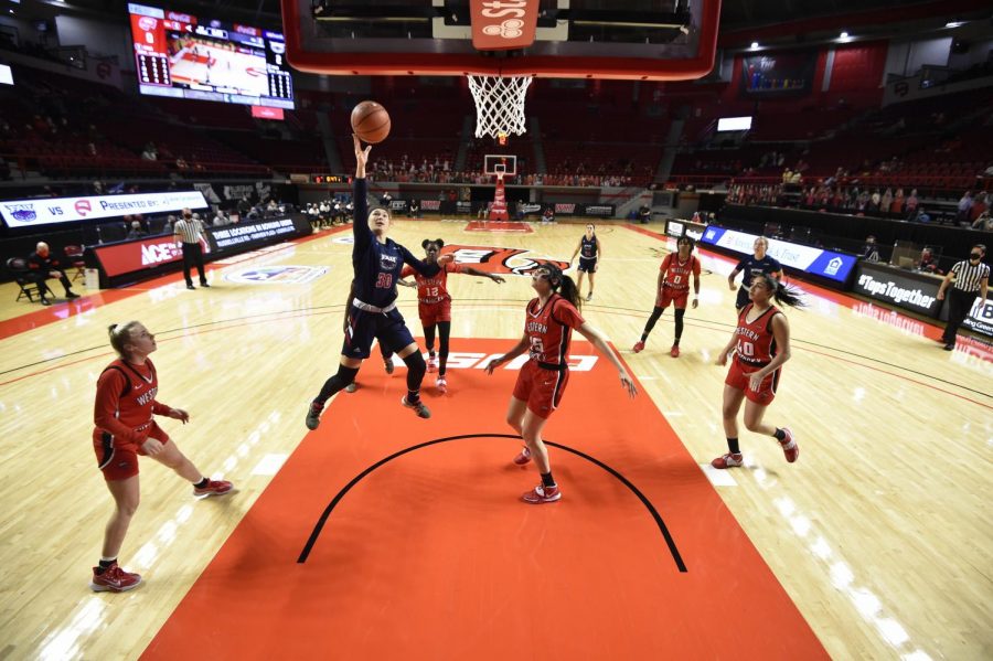 Janeta+Rozentale+%28pictured+blue%2C+%2330%29+goes+up+for+a+layup+against+Western+Kentucky.+Photo+courtesy+of+FAU+Athletics.