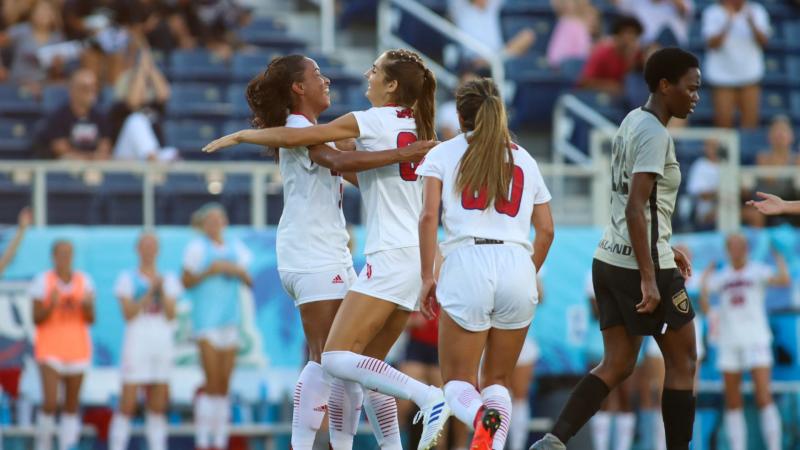 Kaylin Johnston (pictured middle) embraces Bri Austin in celebration after scoring her first goal against Oakland on Aug. 19, 2021.  