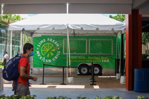 A student walks by Lime Fresh Mexican Grill at the Boca Raton FAU Campus. Lime Fresh is the latest food option on campus. Photo by Eston Parker III.