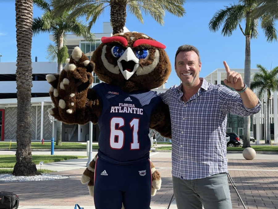 The College Tour host Alex Boylan poses with school mascot, Owlsley.