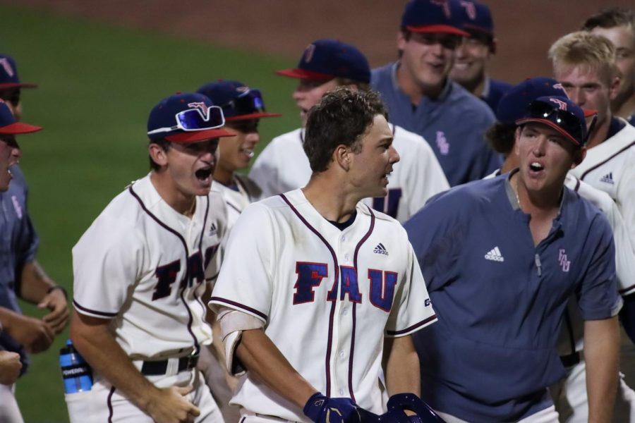 Nolan Schanuel (center) celebrates with his teammates after securing the lead against UCF on April 5, 2022. Schanel hit his ninth homerun of the season while also improving his average to .423 so far.