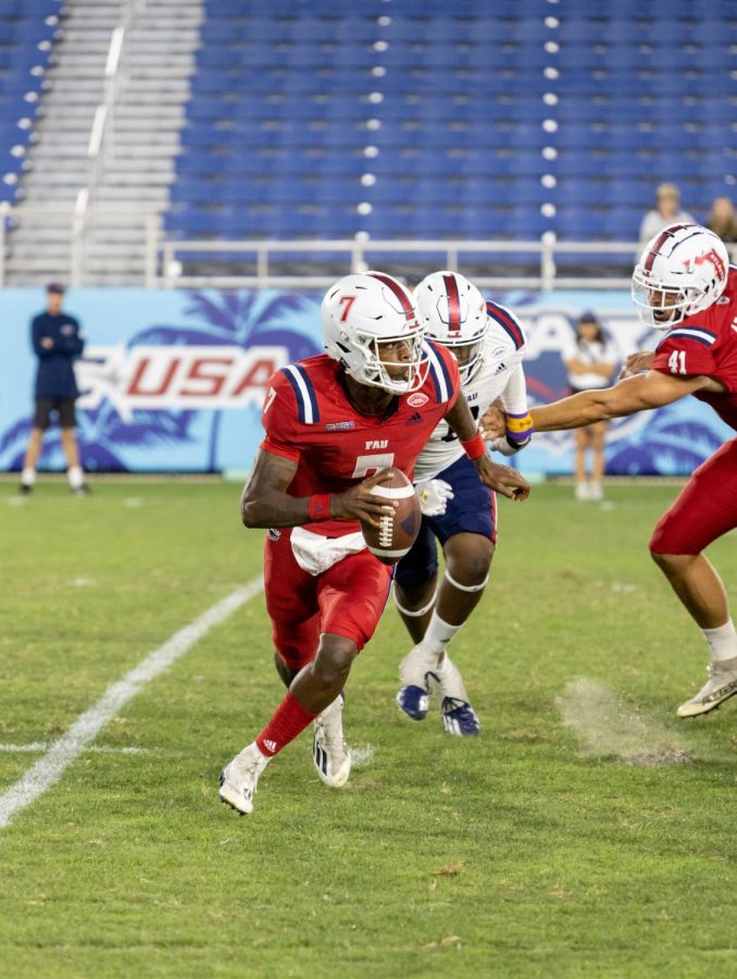 NKosi Perry avoids pressure from Jaylen Joyner during the 2022 Spring Game on April 9, 2022. Perry was able to run for one touchdown in the red teams 15-13 victory.