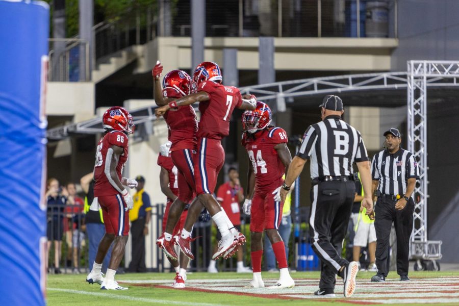 Quarterback NKosi Perry (#7) celebrates with wide receiver JeQuan Burton (#8), who scored the touchdown against Charlotte on Aug. 27, 2022.