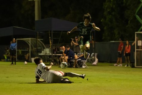 Defender Davide Viola slides to take control of the ball for FAU against Charlotte on Oct. 9, 2022.