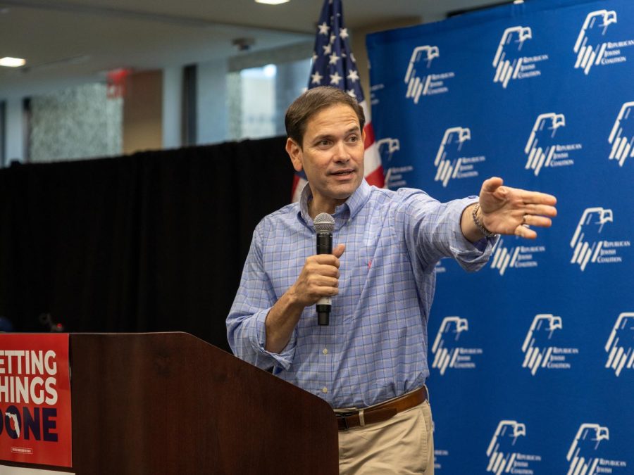 Marco Rubio takes the stand, thanking and gesturing towards his previous speakers for the energy they brought with them.