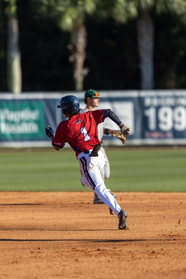 Armando Albert runs for second base after a double on Saturday against USF.