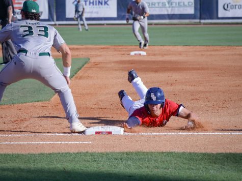 John Schroeder slides back to first base after attempting to steal second on Feb. 25, 2023. 