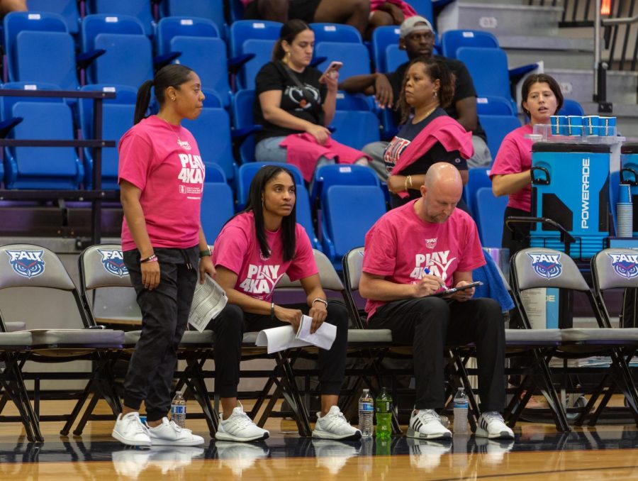 Jennifer Sullivan (middle) and assistant coaches, Jessica Jackson (left) and Matt Ruffing (right) coaching in pink Play 4 Kay t-shirts. Play 4 Kay is a breast cancer awareness initiative. 
