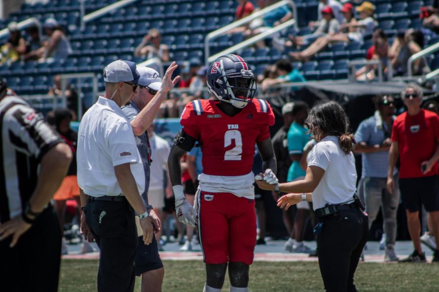 Senior cornerback Romain Smoke Mungin (#2) is walked off the field by medical staff after a tough down on April 15, 2023 during Spring Game.