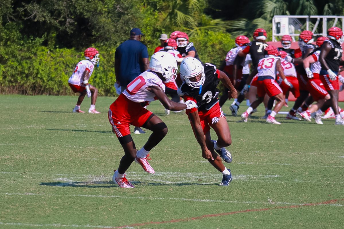 FAU defensive back Josh Moore (#10) squaring up against running back Larry McCammon III (#3) at practice. August 30, 2023.