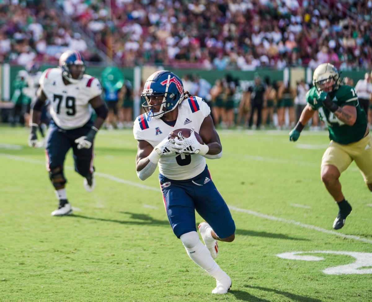 FAU graduate running back Kobe Lewis (#5) running after a pass from junior quarterback Daniel Richardson for a first down in FAUs 56-14 win over USF on Oct. 14, 2023.