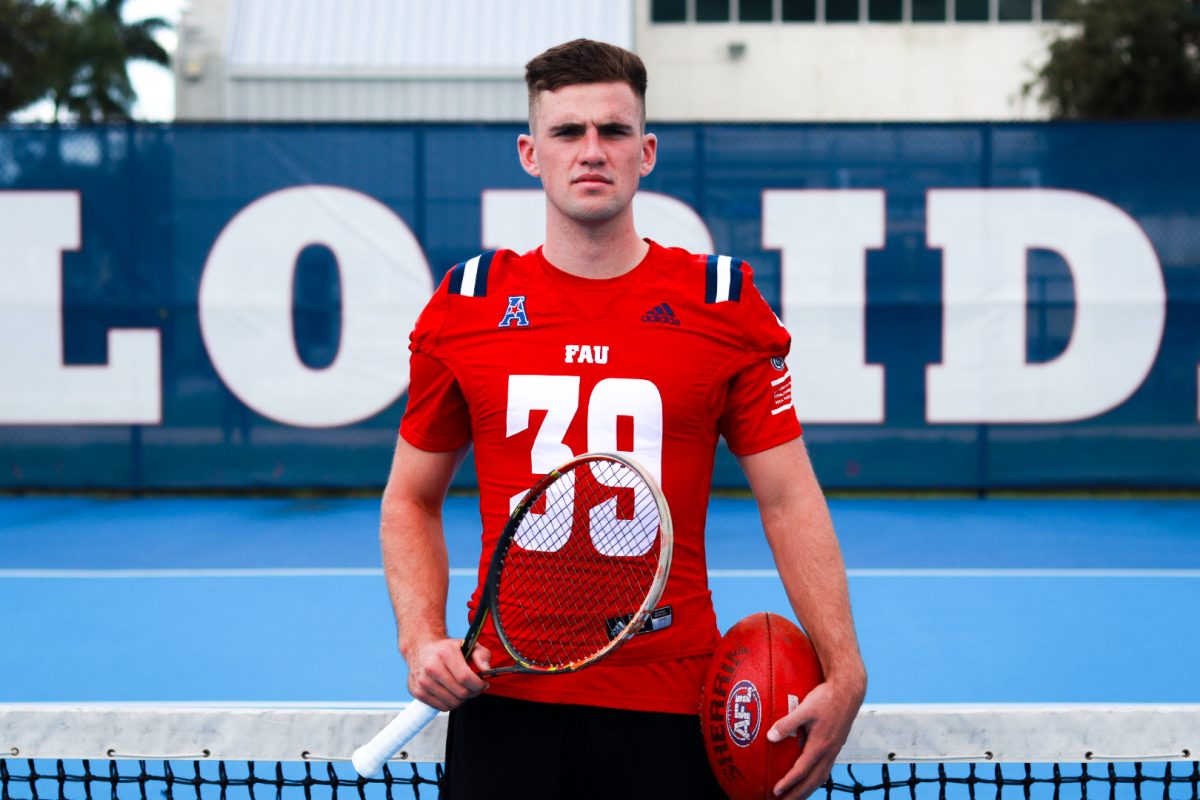 While tennis has been in his lineage, freshman punter Nick Salmon also played Australian Rules Football at 12-years-old and again at 15, winning national titles both times. In this photo, Salmon is pictured holding a tennis racket and the Australian Football League (AFL) football.