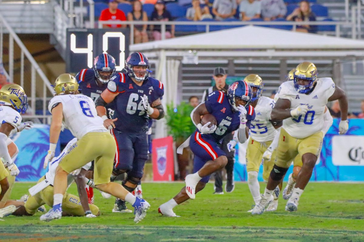 Graduate running back Kobe Lewis (#5) breaks through Tulsas defense for an FAU first down at Howard Schnellenberger Field in Boca Raton, Fla, on Oct. 7, 2023.