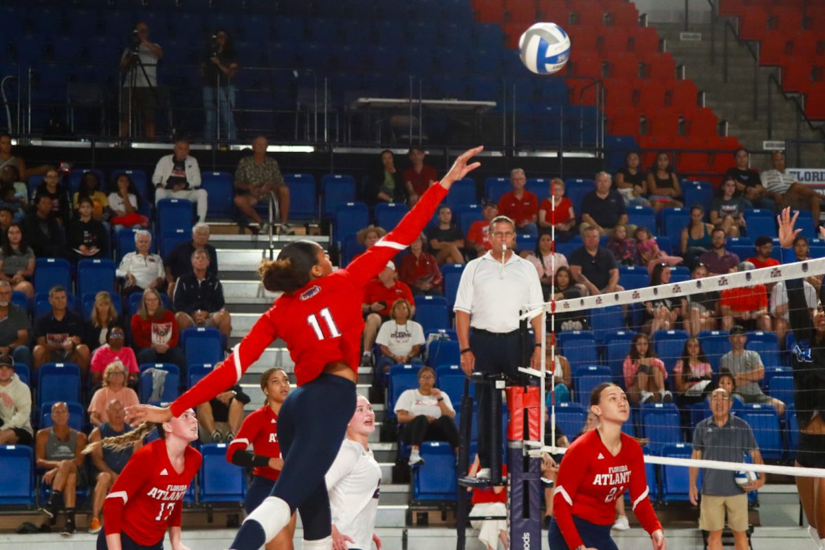 FAU sophomore outside hitter Arianna Beckham (#11) goes for a kill against SMU at Eleanor R. Baldwin Arena on Oct. 8, 2023.