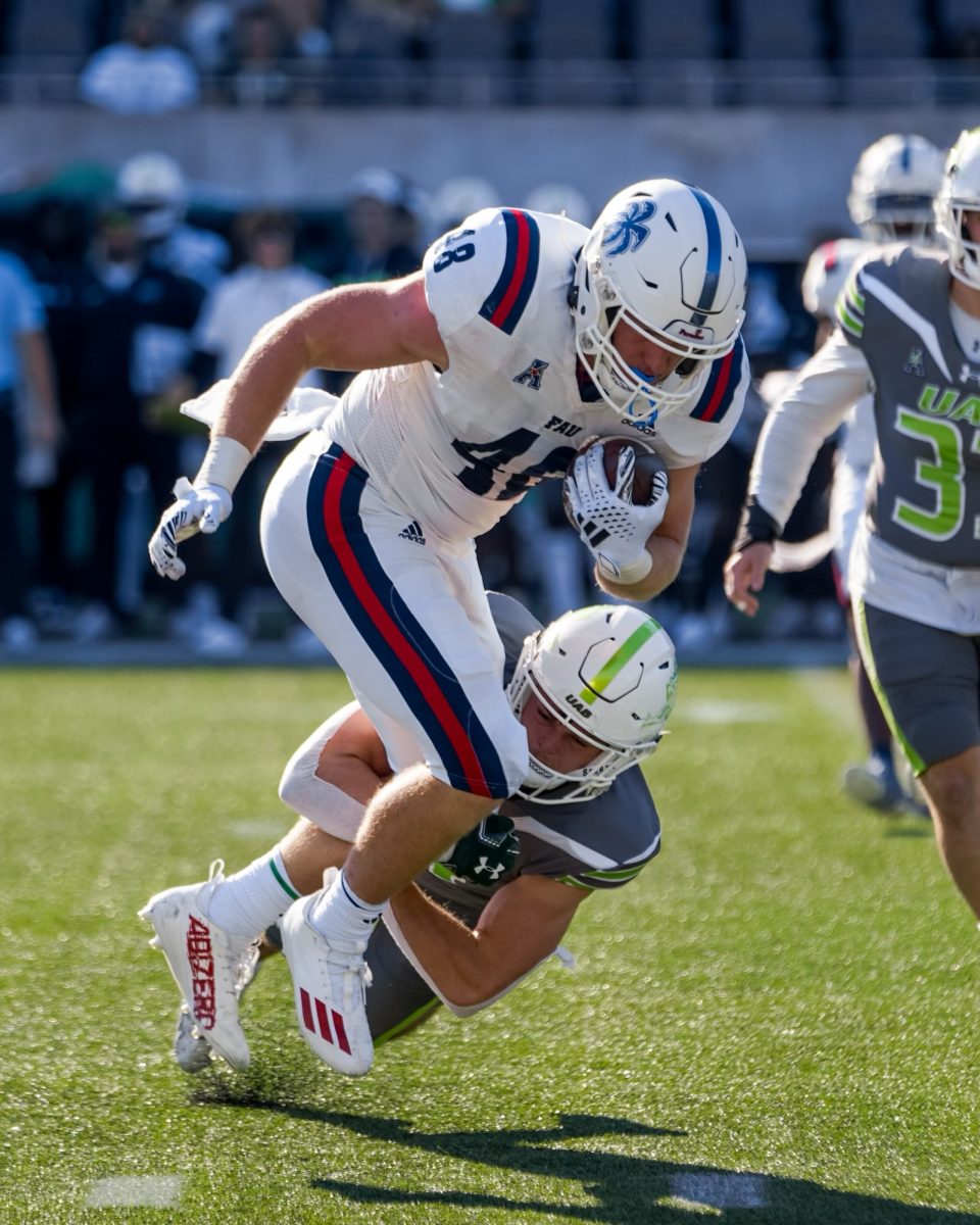 FAU freshman tight end (#48) Zeke Moore breaking a tackle for a first down during the Owls 45-42 loss to the University of Alabama at Birmingham on the road on Saturday, Nov. 4, 2023.