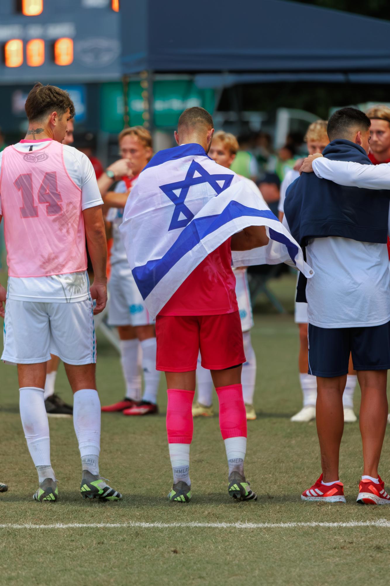 Rotem Fadida draping the Israel flag before the Owls 2-0 win against the University of Alabama at Birmingham on Oct. 8, 2023.