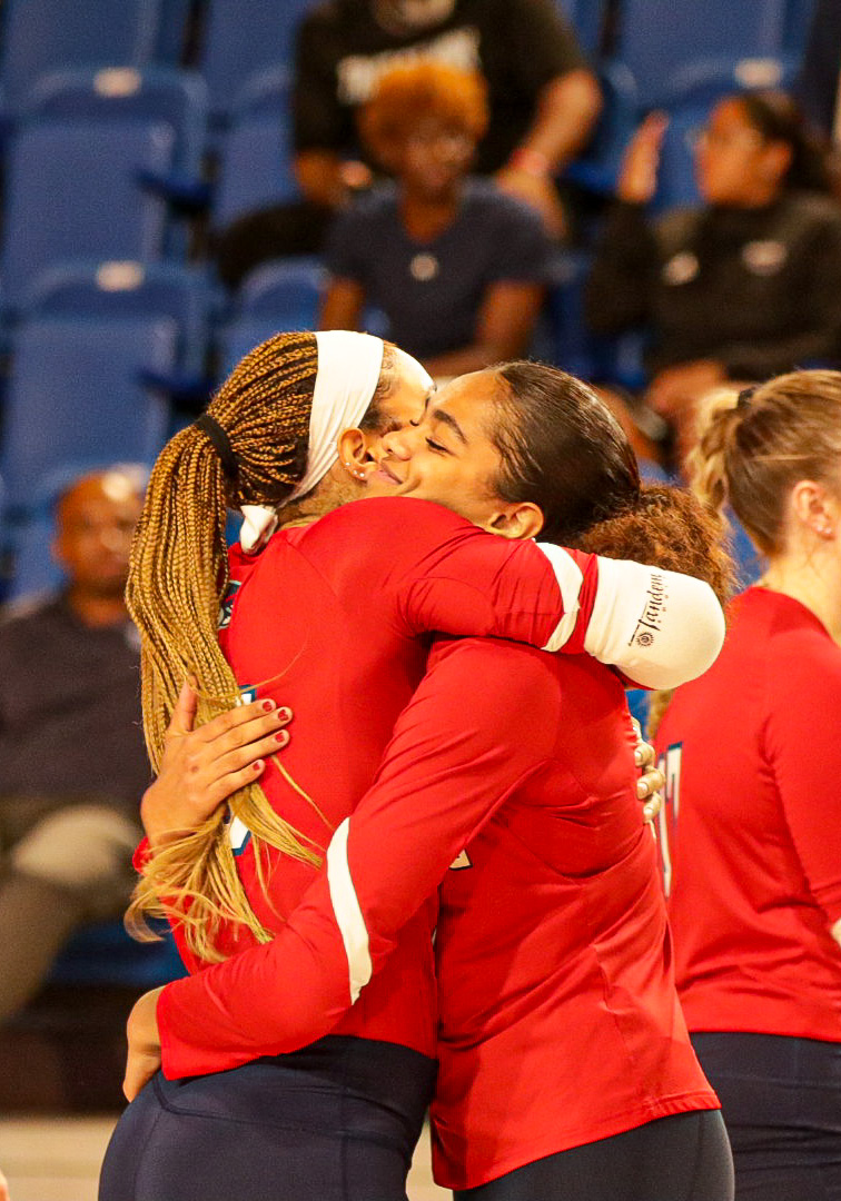 FAU outside hitters junior Romina Cornelio and sophomore Arianna Beckham embrace before the match against USF on Thursday, Nov. 16, 2023 at Eleanor R. Baldwin Arena.