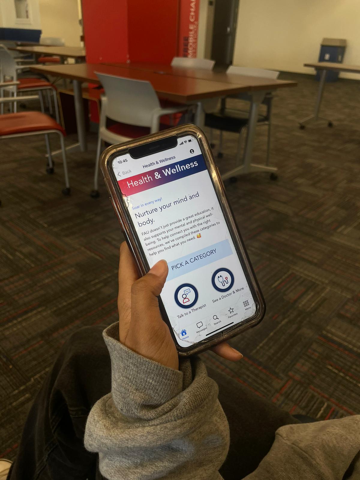 A student accessing the Health and Wellness tab through the MyFAU app