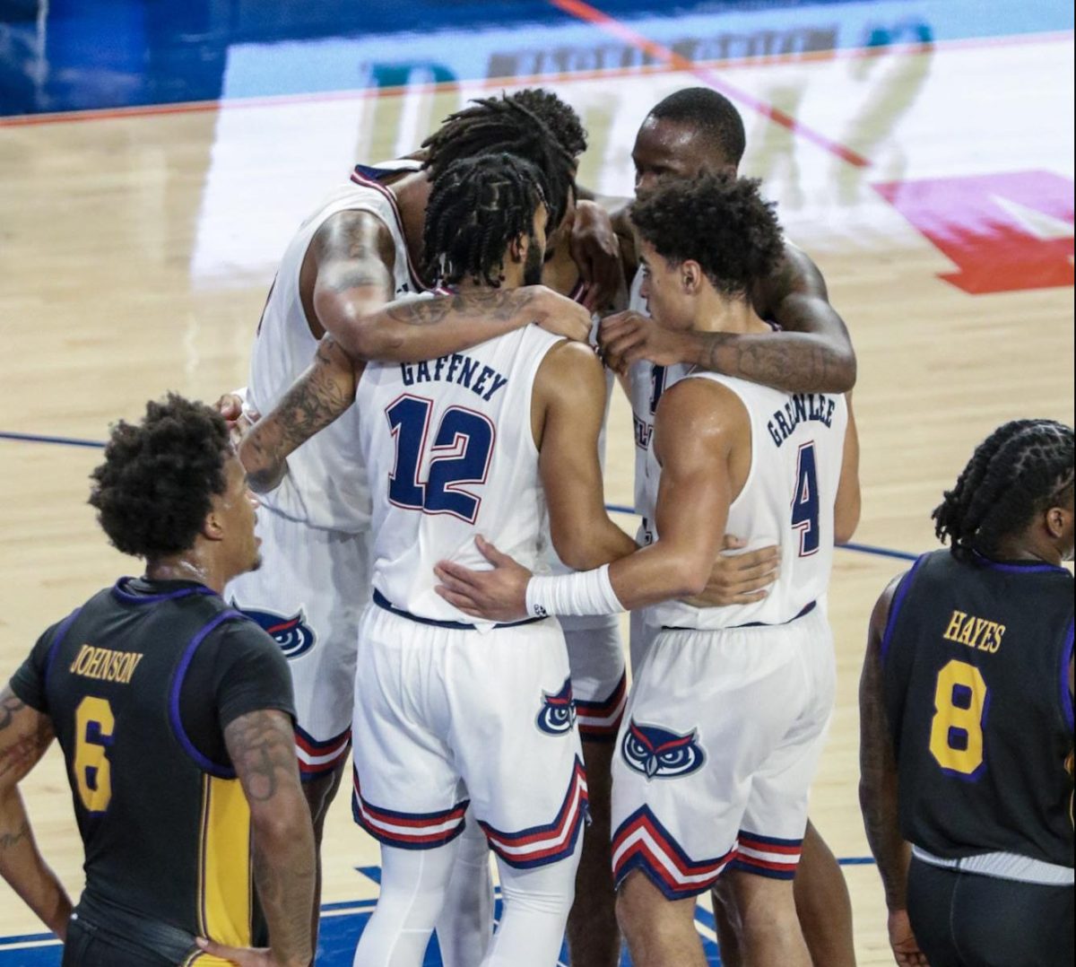 The FAU Mens basketball team in a quick huddle before an inbound pass in their match against ECU on Tuesday, Jan. 2 2024