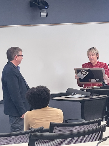 Kevin Wagner, (left) receiving a certificate from current Faculty Senate President, Kim Dunn (right) on behalf of Florida Atlantic University for his work as a member and past president of the Faculty Senate over the past year. 