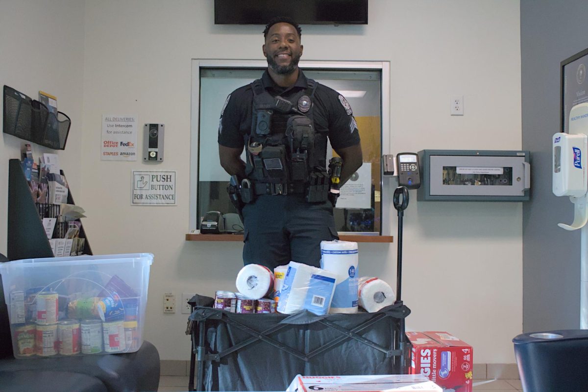 Florida Atlantic University Police Department Sgt. Gassant poses near the recent “Hurricane Melissa” donations in the Florida Atlantic University Police Department on Nov. 17. 